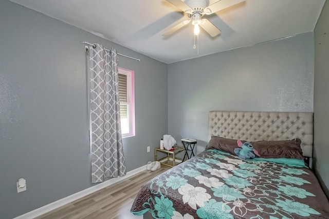 bedroom with ceiling fan and hardwood / wood-style flooring