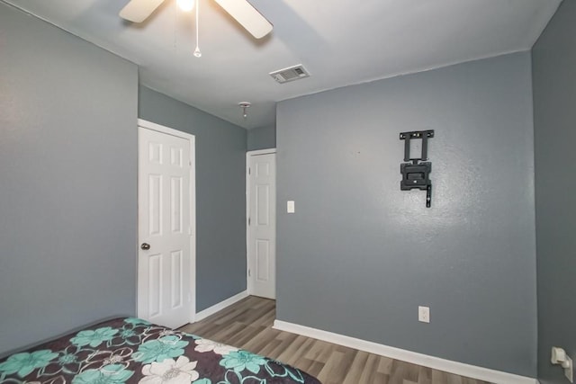 unfurnished bedroom with wood-type flooring and ceiling fan