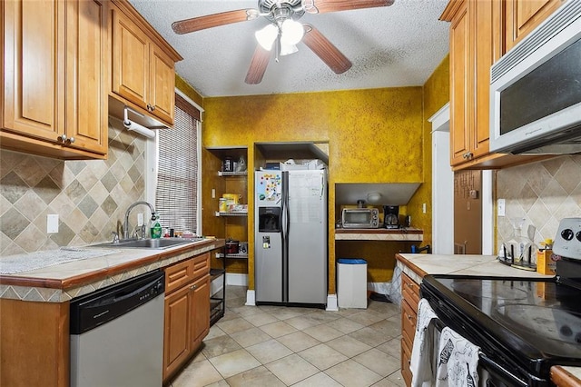 kitchen with backsplash, tile countertops, stainless steel appliances, light tile patterned flooring, and ceiling fan