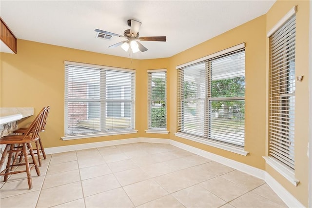 tiled dining area featuring ceiling fan