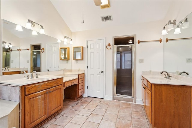 bathroom with tile patterned flooring, vanity, an enclosed shower, and vaulted ceiling