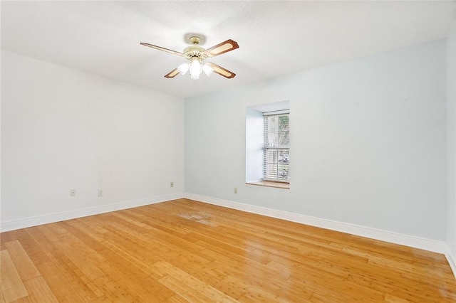 empty room featuring ceiling fan and light wood-type flooring