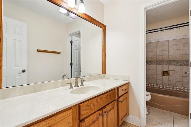 full bathroom featuring tile patterned flooring, vanity, toilet, and tiled shower / bath