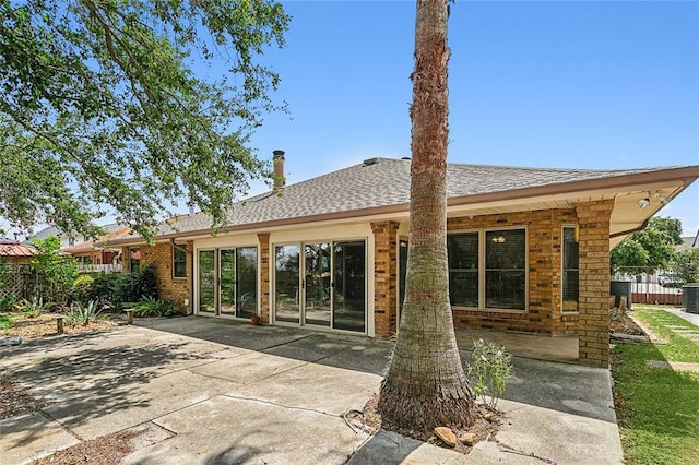 back of property featuring central AC unit and a patio