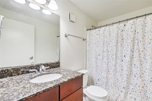 bathroom with vanity, toilet, and a shower with shower curtain