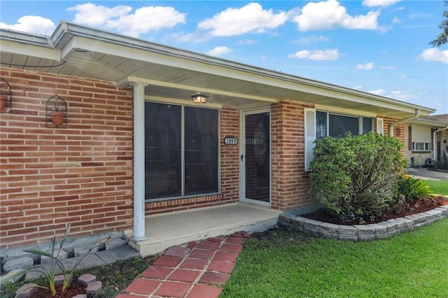 property entrance with brick siding