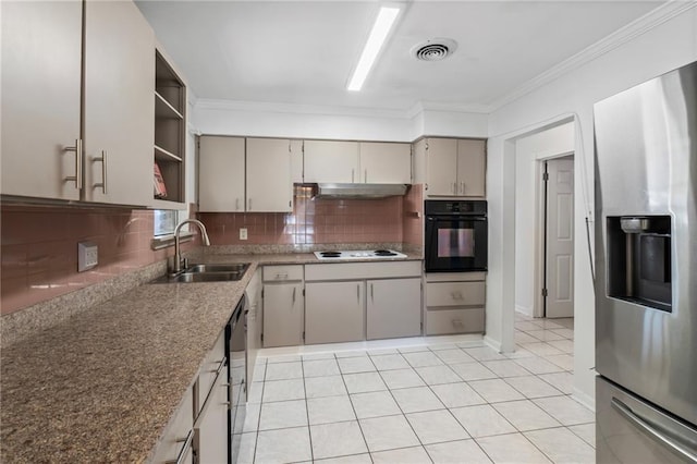 kitchen featuring under cabinet range hood, a sink, visible vents, black appliances, and crown molding