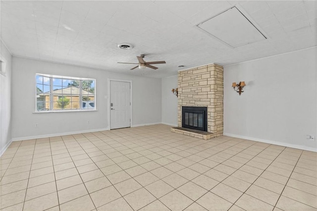 unfurnished living room featuring a fireplace, ceiling fan, and light tile patterned flooring