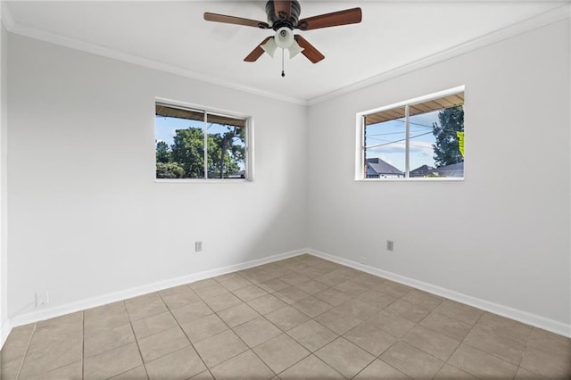 tiled empty room with ceiling fan and ornamental molding