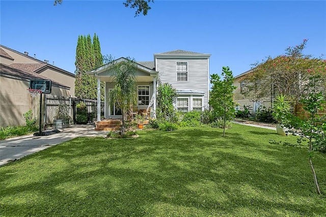 rear view of property featuring a yard