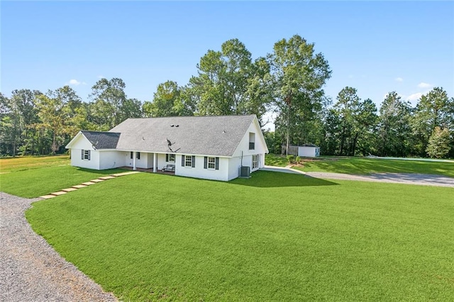 rear view of property with a lawn and central AC unit