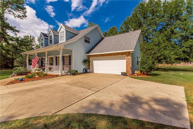 view of front of house with a garage, covered porch, and a front lawn