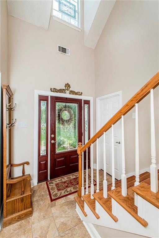 foyer entrance featuring a towering ceiling