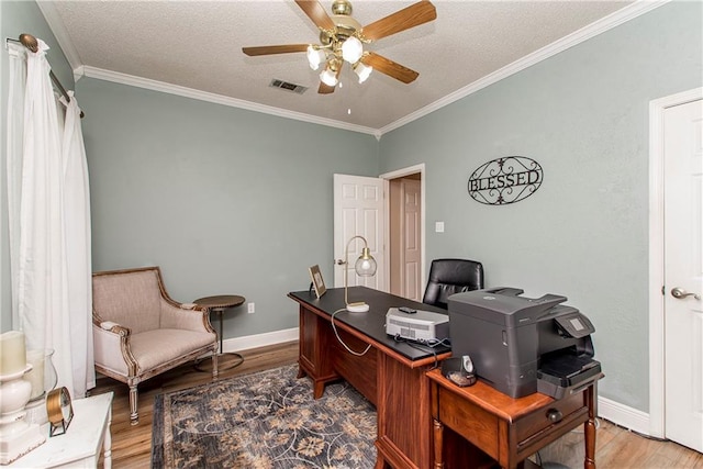 office space with ceiling fan, ornamental molding, a textured ceiling, and hardwood / wood-style flooring