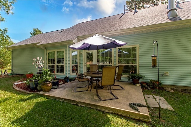 back of property featuring a yard and a patio