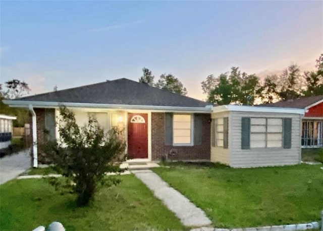 ranch-style home with a yard