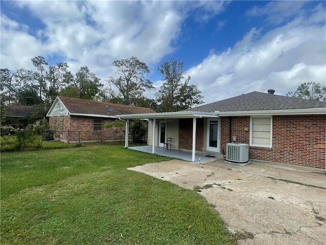 back of house with a yard, a patio, and central AC unit