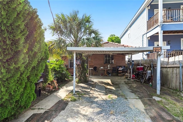 view of patio featuring a balcony and a carport