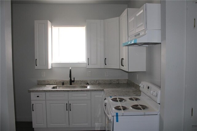 kitchen featuring white cabinets, electric stove, and sink