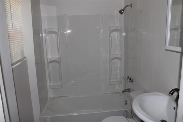 full bathroom with toilet, sink, and washtub / shower combination