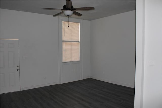 spare room featuring ceiling fan and dark hardwood / wood-style floors