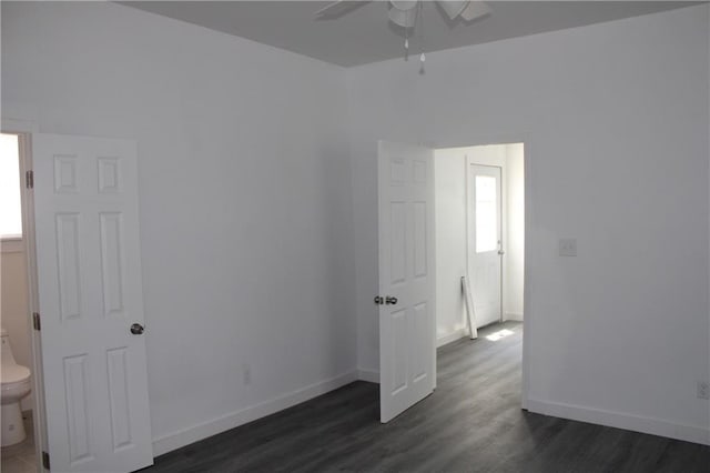 unfurnished room featuring ceiling fan and dark hardwood / wood-style flooring