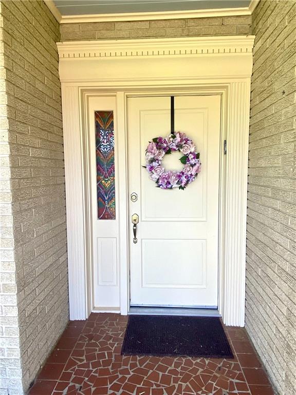 property entrance featuring brick siding