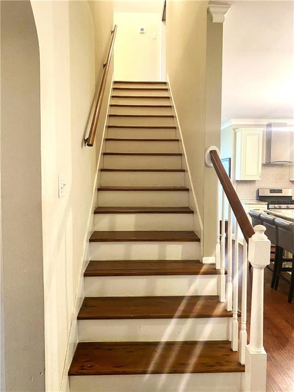 stairway with wood finished floors