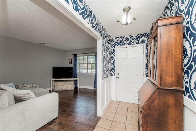 foyer entrance featuring a textured ceiling and hardwood / wood-style floors