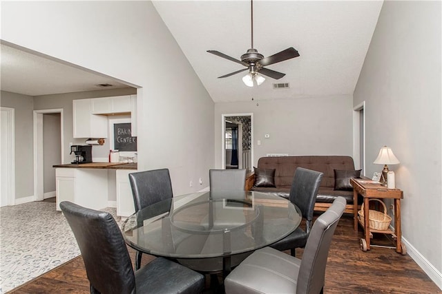 dining area with vaulted ceiling, ceiling fan, and dark hardwood / wood-style floors