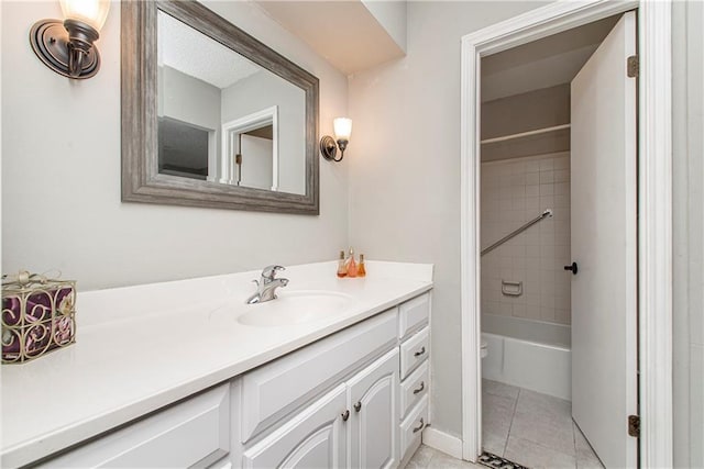 bathroom with vanity, tiled shower / bath combo, and tile patterned floors