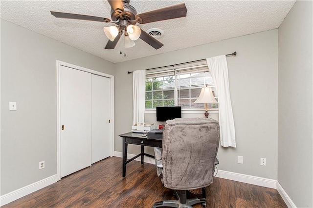 office space featuring dark wood-type flooring, ceiling fan, and a textured ceiling