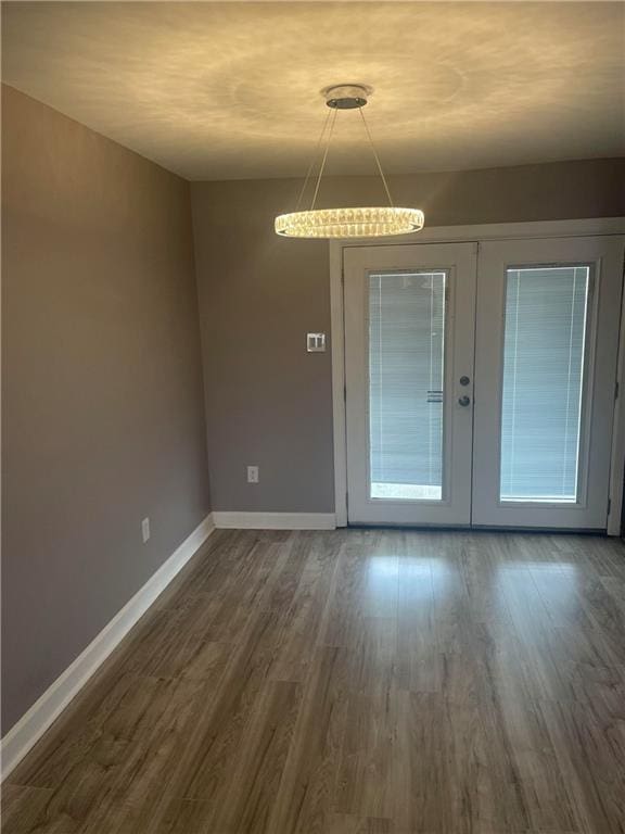 doorway to outside featuring a wealth of natural light, dark hardwood / wood-style flooring, and french doors