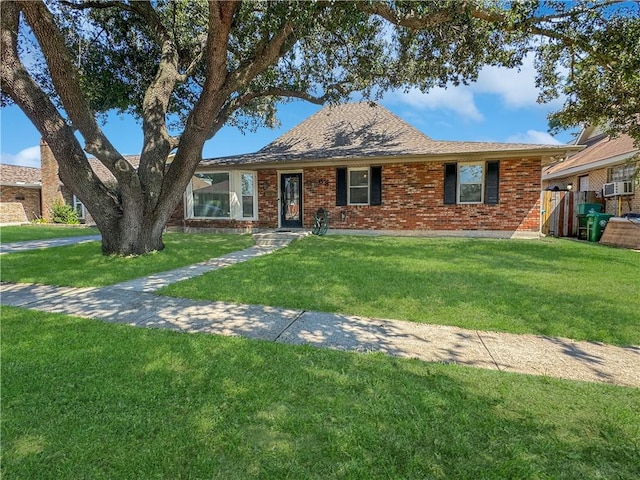 ranch-style home with a playground, cooling unit, and a front lawn