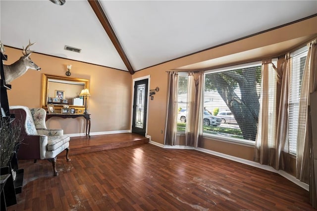 unfurnished room with wood-type flooring and lofted ceiling with beams