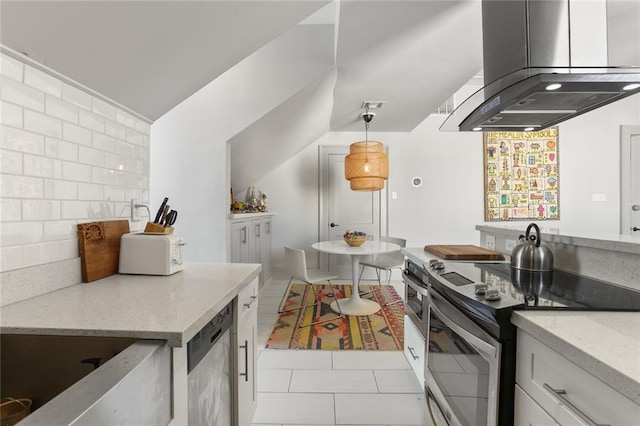 kitchen featuring white cabinets, hanging light fixtures, backsplash, appliances with stainless steel finishes, and light tile patterned floors