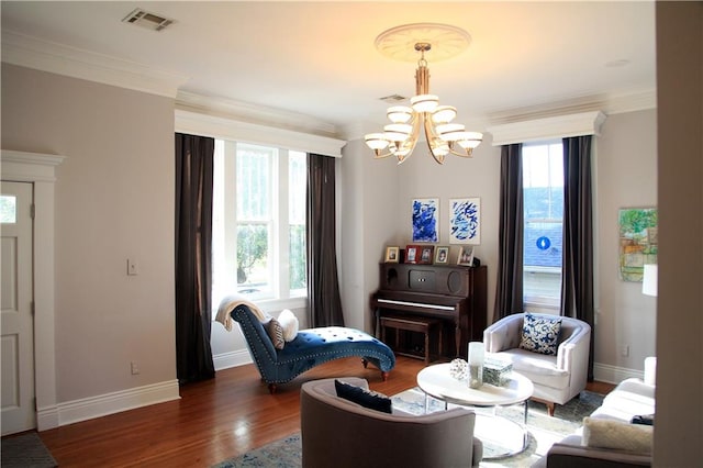 living room with crown molding, dark wood-type flooring, and a notable chandelier