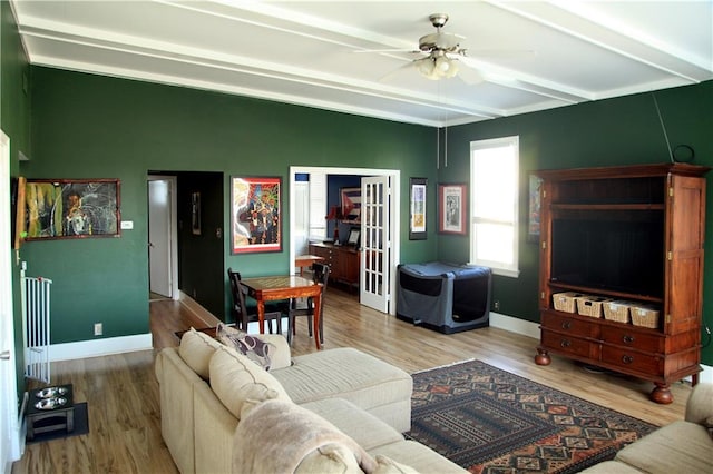 living room with radiator heating unit, beam ceiling, ceiling fan, and hardwood / wood-style floors