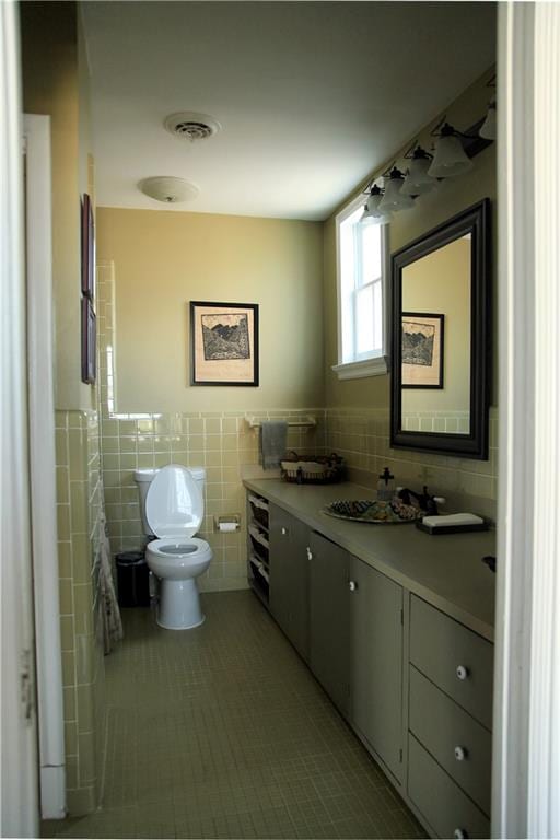 bathroom with vanity, tile walls, toilet, and tile patterned floors