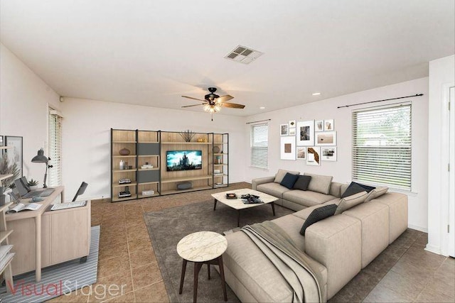 living room featuring tile patterned flooring and ceiling fan