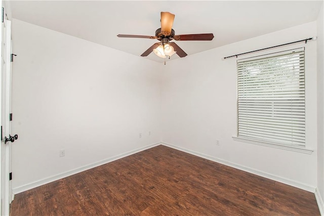 spare room with dark hardwood / wood-style floors and ceiling fan