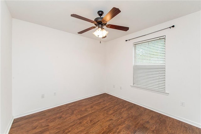 empty room with ceiling fan and dark hardwood / wood-style floors