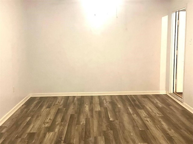 empty room featuring dark hardwood / wood-style flooring