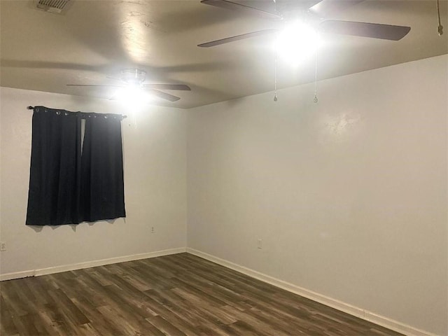 spare room featuring dark wood-type flooring