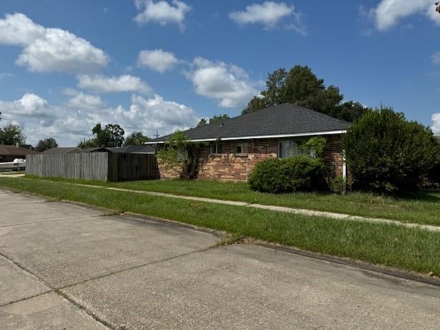 view of side of property with a lawn