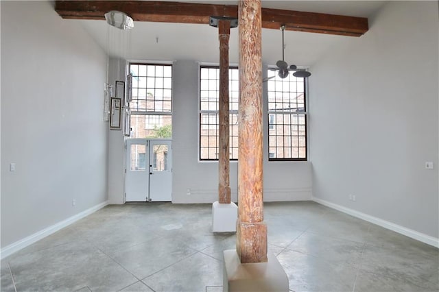 interior space featuring a chandelier and beam ceiling