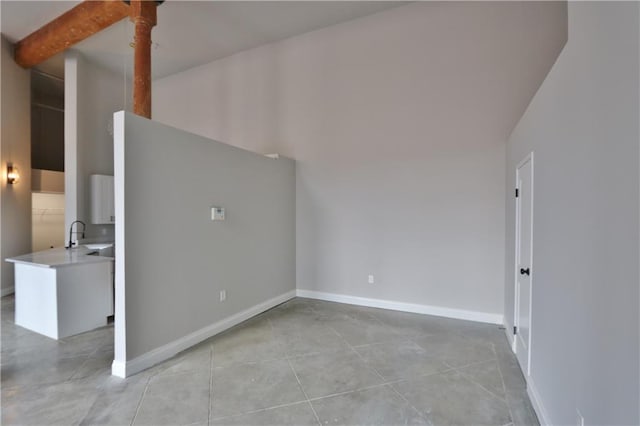 interior space with a high ceiling and concrete flooring