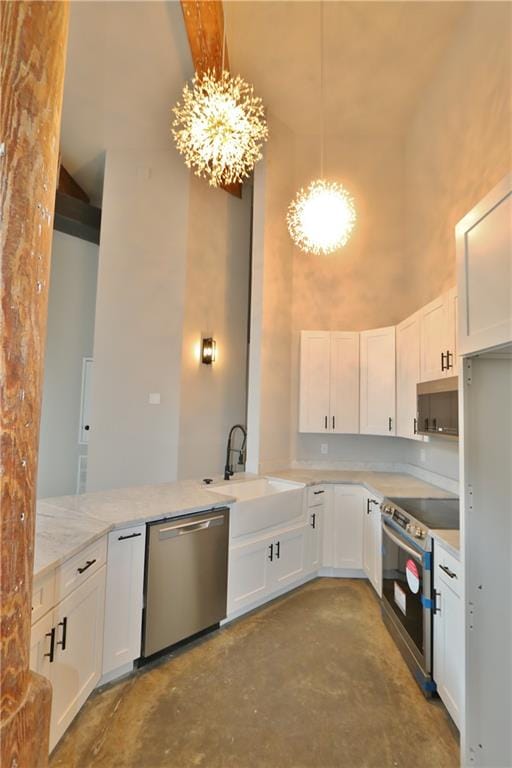 kitchen featuring white cabinets, light stone countertops, stainless steel appliances, a chandelier, and sink