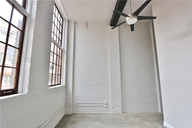 tiled empty room featuring a towering ceiling