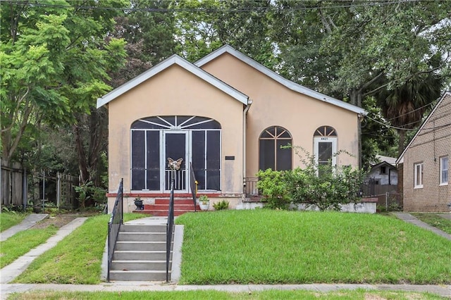 bungalow-style home with a front lawn